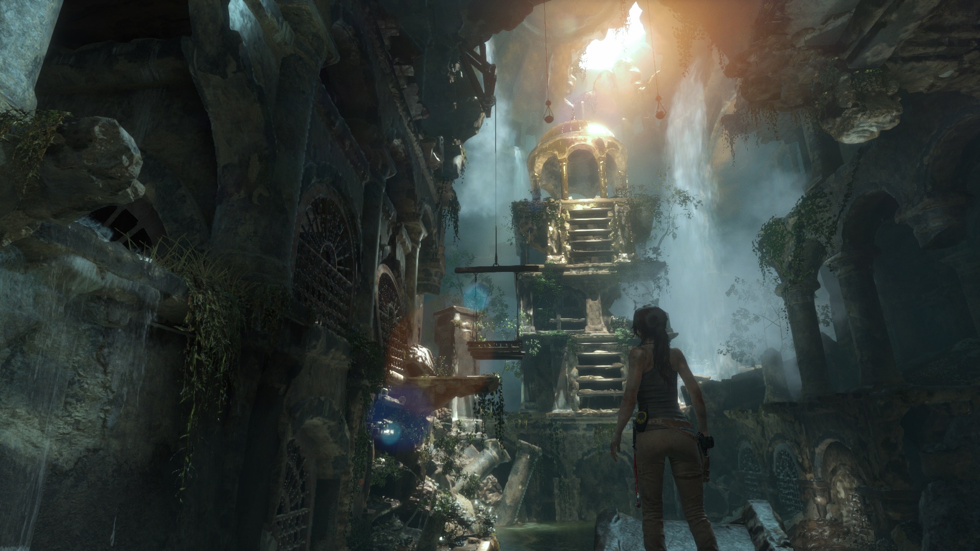 Lara looks up at a golden underground chapel