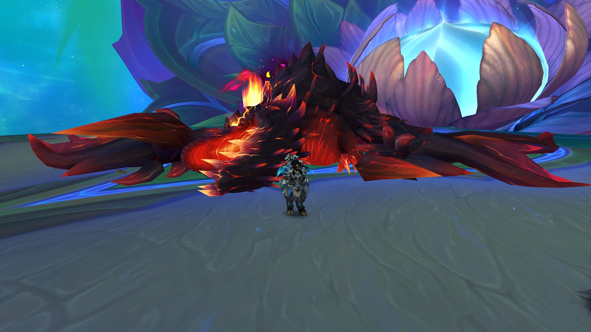 A Tauren Paladin standing in front of the dragon Fyrakk after his defeat